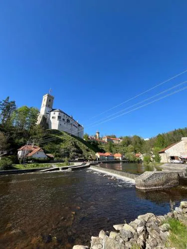 A room by a weir with a view of Rožmberk Castle