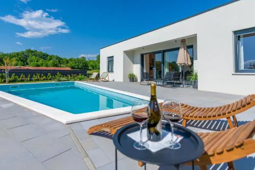 Villa The Pool House, a lush modern villa with a pool