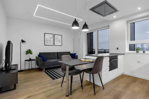 12th Floor Wola Modern Apartment by BookingHost