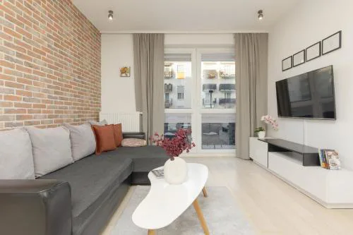 Subtle Colors Apartment in Warsaw with Furnished Balcony by Noclegi Renters