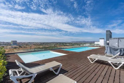Rooftop Pools & Balcony Haven by HostWise